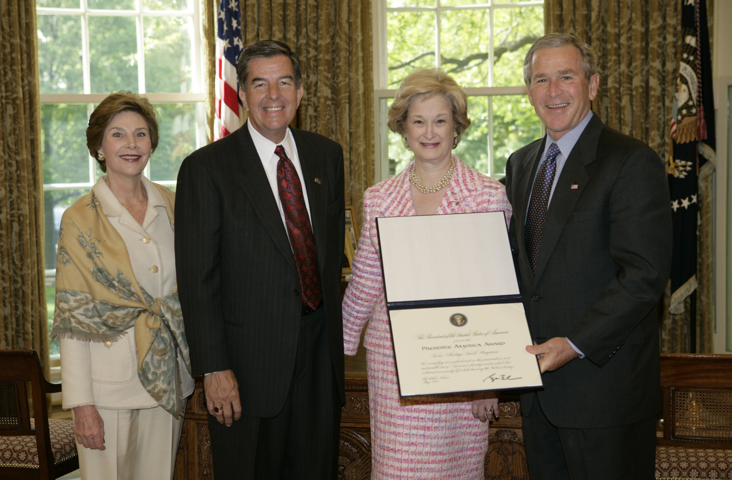 President George W. Bush and Laura Bush present the 2005 Preserve America Presidential Award to members of the Texas Historical Commission in the Oval Office Monday, May 2, 2005. They are Larry Oaks, Executive Director, of Leander, Texas, and Diane Bumpas, Commissioner, of Dallas. (White House photo by Eric Draper)