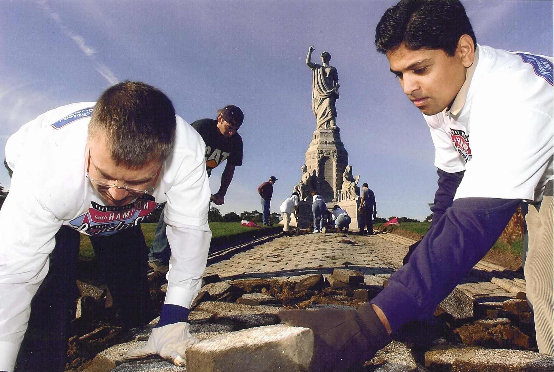 On Tuesday, October 14, 2003, the day following Columbus Day, Hampton volunteers from Boston and Providence traveled back to were the first Americans arrived to refurbish a symbolic piece of U.S. history. Since its dedication more that 100 years ago, the 81 foot tall National Monument to the Forefathers in Plymouth MA – one of the nations largest solid granite statues – has seen its image of the lady “Faith,” her pedestal and walkway of historic pavers deteriorate from time and weather. In an event to mark