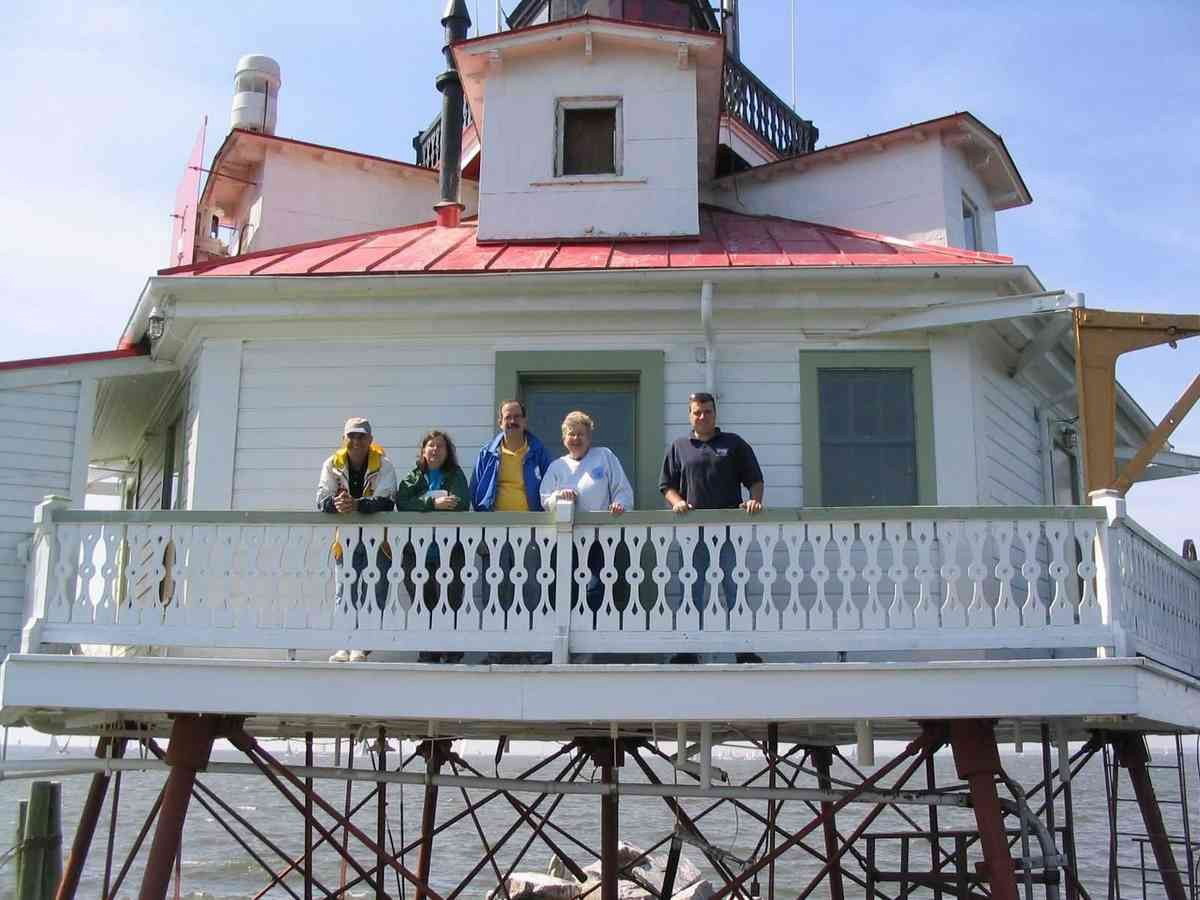 Two mini-grants from the Annapolis, London Town, and South County Heritage Area, funded in part by the Maryland Heritage Areas Authority, have supported preservation and interpretation projects at Thomas Point Shoal Light, a National Historic Landmark lighthouse in its original location in the Chesapeake Bay near Annapolis, Maryland. In this image, preservationists and volunteers take a break from their restoration work on the Thomas Point Shoal Light.