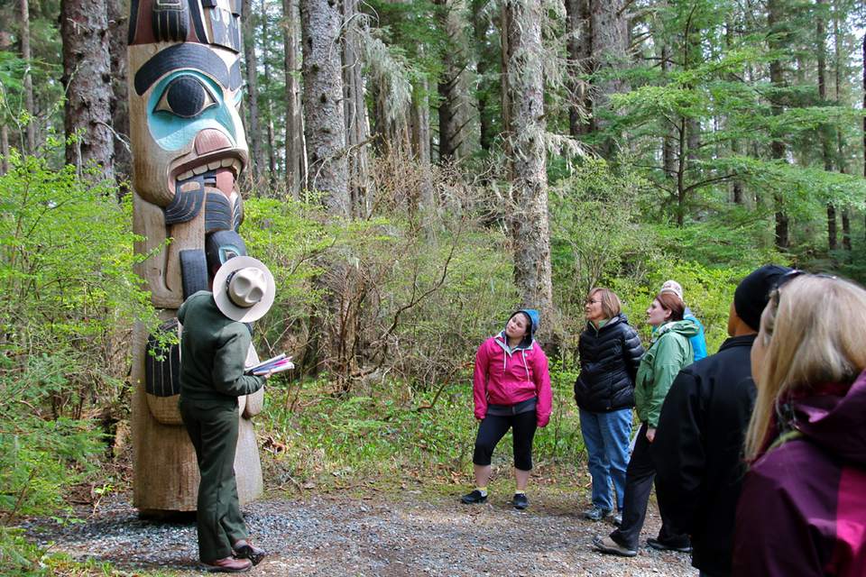 A Park Ranger leads a totem pole tour in Sitka National Historic Park.