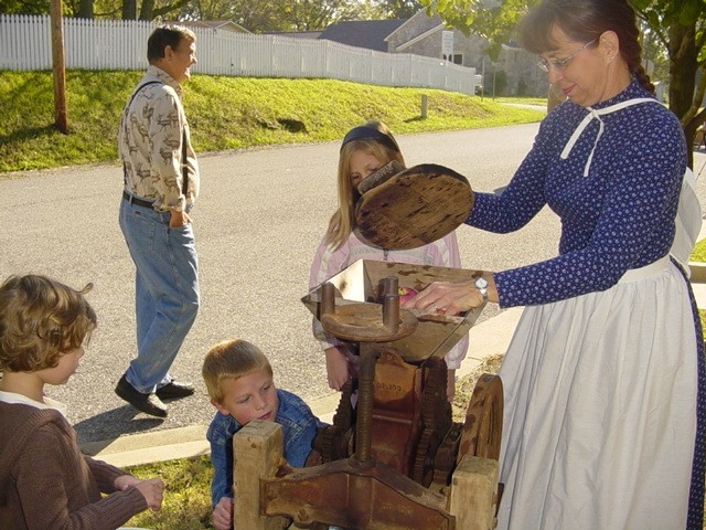 A costumed interpreter gives a demonstration at a farm life event in Batesville, Arkansas.