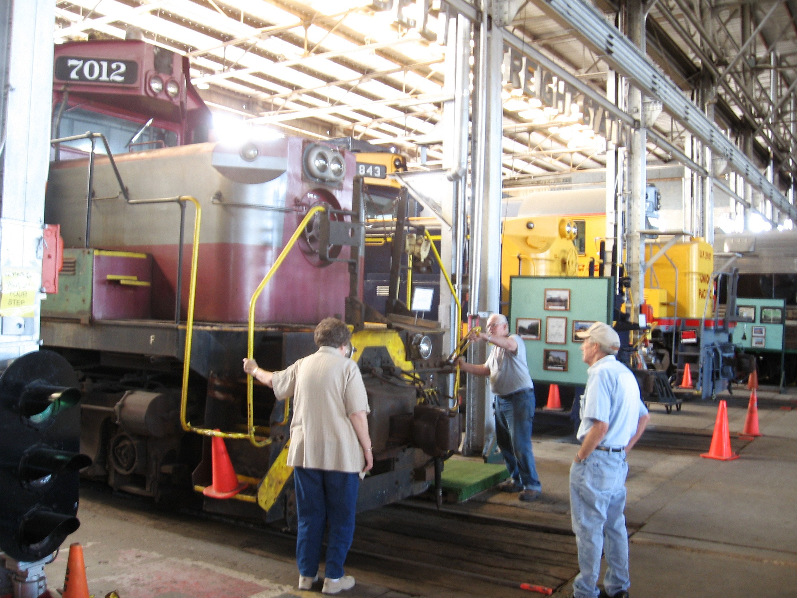 Docent and visitors examining an engine on display at the Rail Road Museum in Pine Bluff, Arkansas