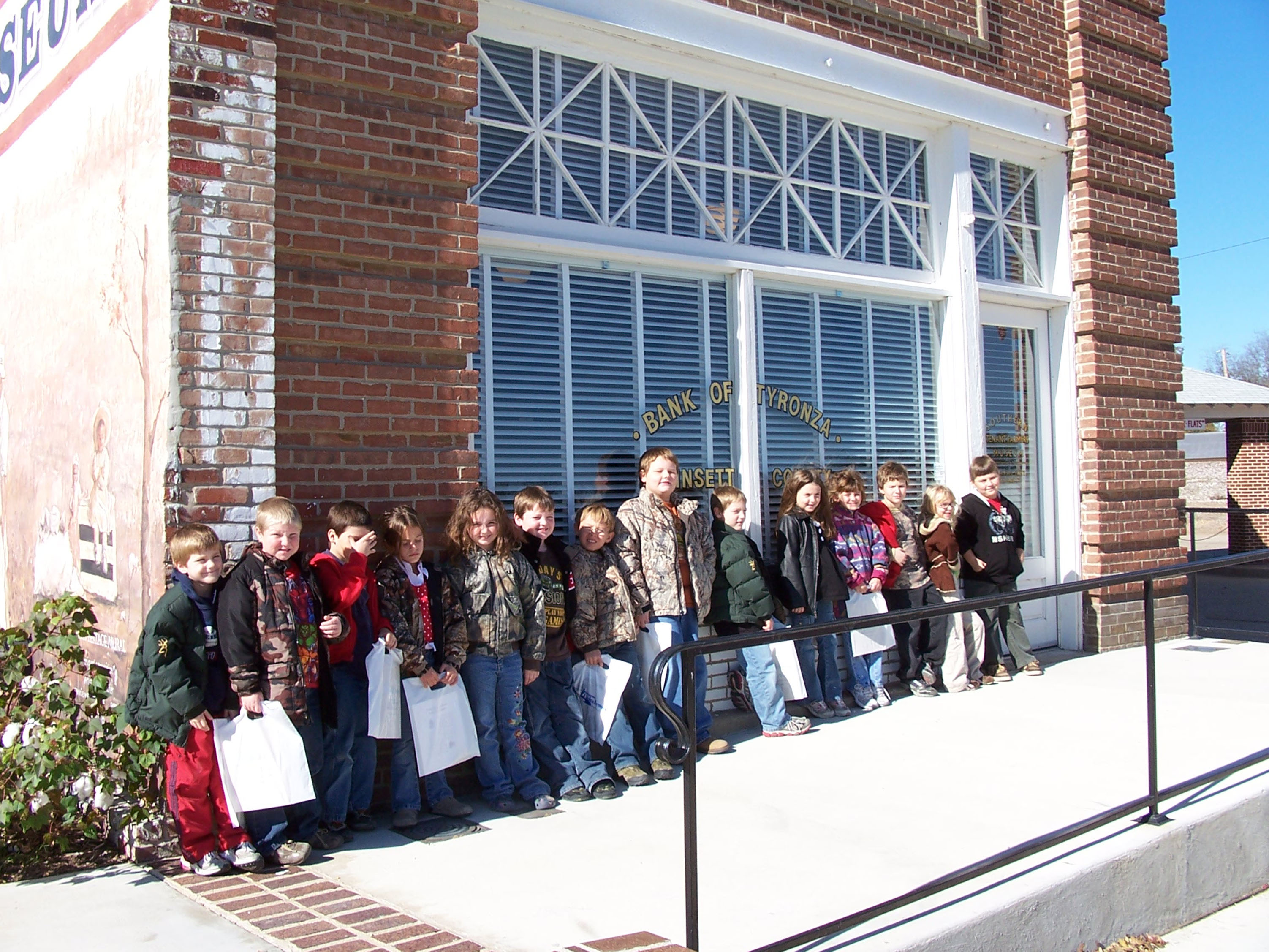 Schoolchildren visit the restored Old Bank of Tyronza building, now part of the Southern Tenant Farmers Museum. The Museum offers activities for seniors and youth, as well as an oral history room.