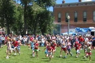 Children enjoy races in a historic downtown park as part of July 4th celebrations in Lake City, Colorado