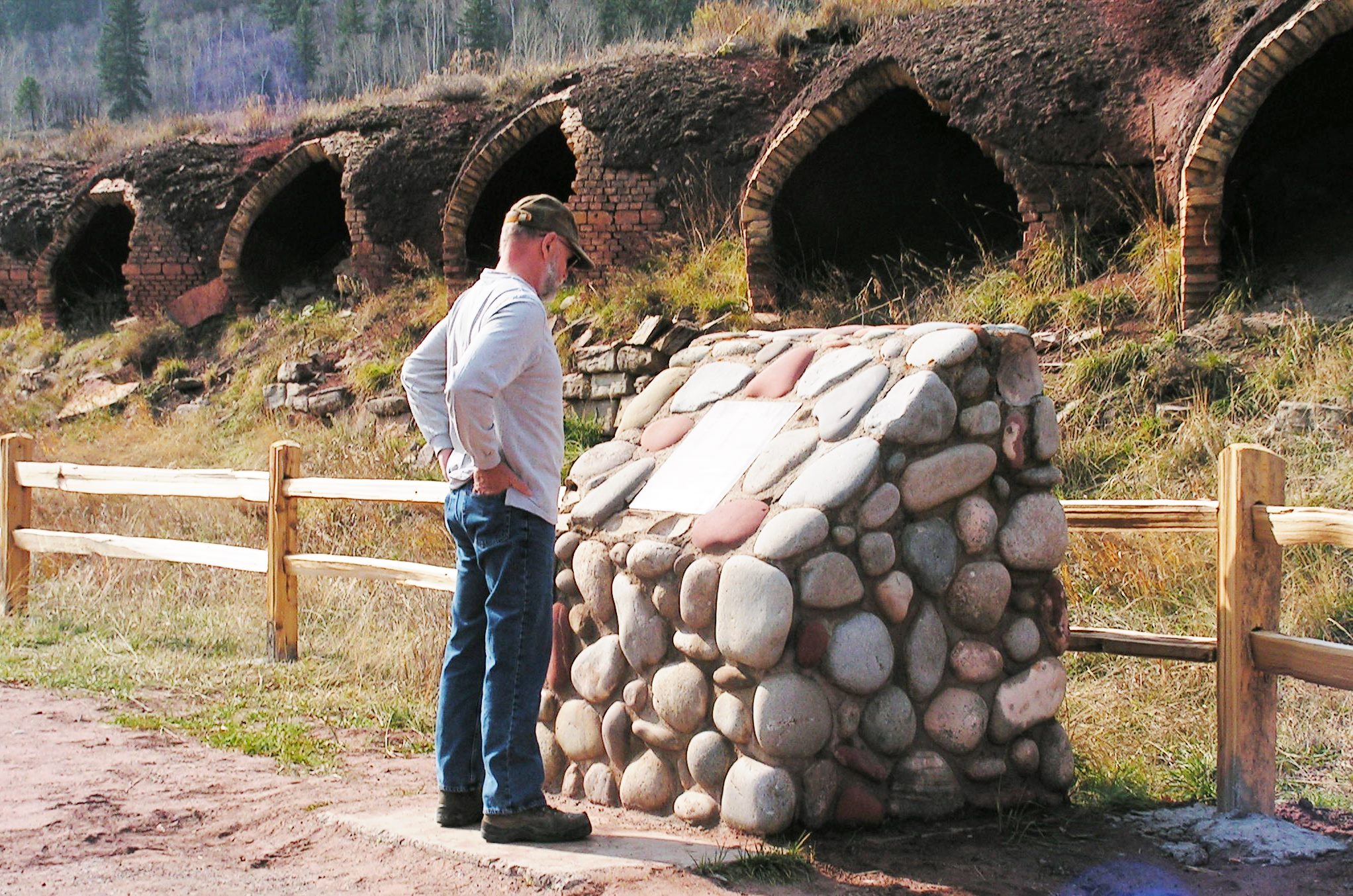 A visitor reads about the Redstone Coke Ovens. From 1900 to 1909 (and again from 1959 to 1961) the Redstone Coke Ovens transformed coal into high-grade coke used to produce iron and steel.