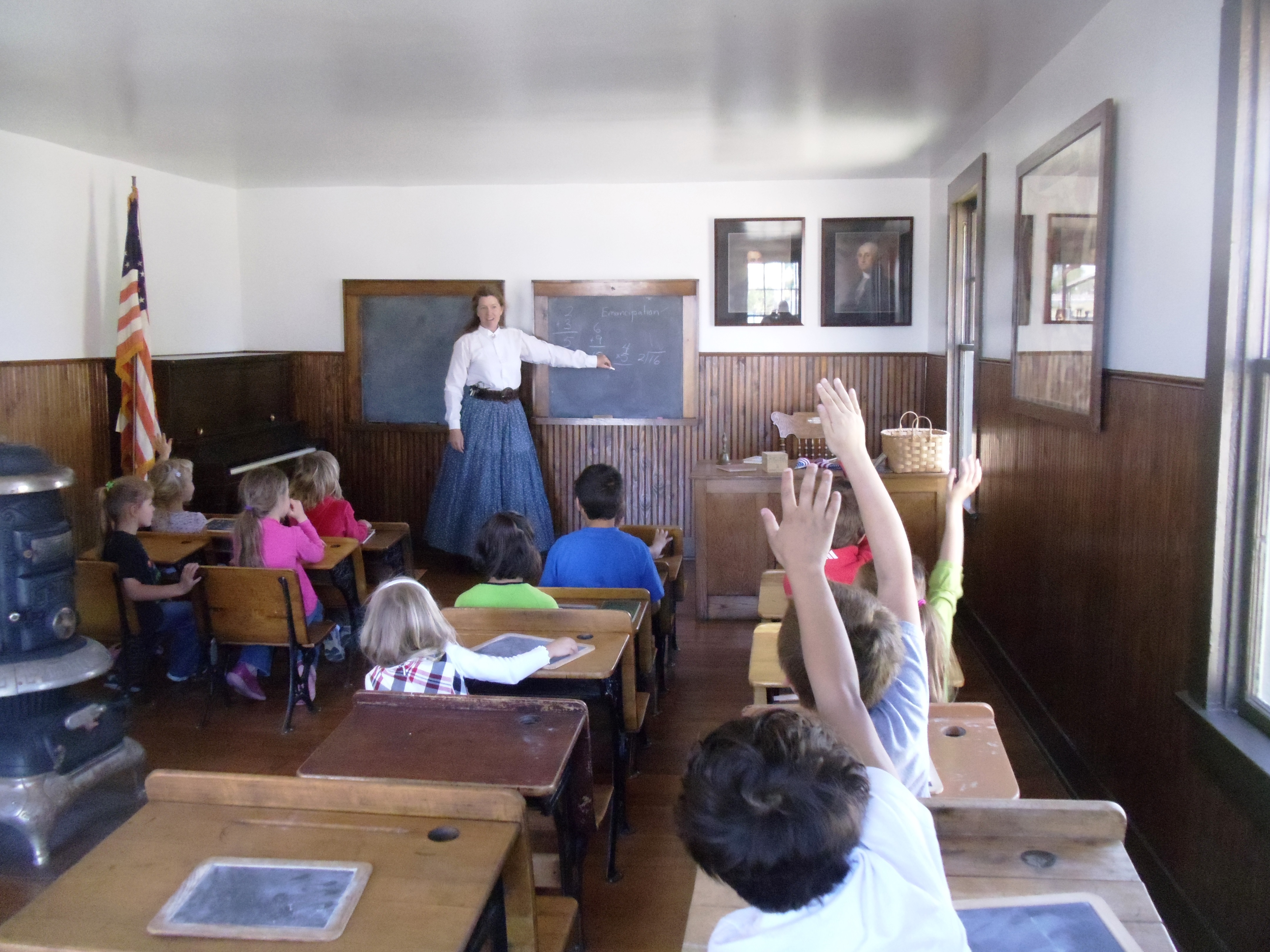 The historic Whitehall Schoolhouse offers students the opportunity to experience learning in a historic classroom with a teacher in period costume.