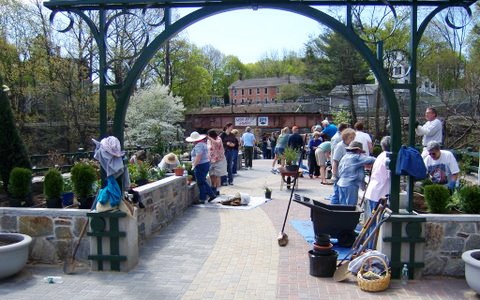Windham, Connecticut's Garden on the Bridge illustrates how historic structures can be creatively reused. The 1857 two arch stone bridge was built as a thoroughfare between two American Thread Company buildings and now houses a garden, enhancing nearby sites.