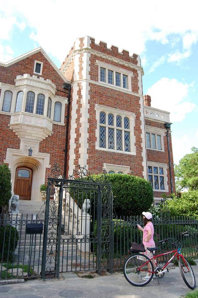 A cyclist pauses in front of the historic Leon Cheek Mansion in Jacksonville, Florida, to hear about it via a podcast tour. The free, downloadable podcast was created by Riverside Avondale Preservation.