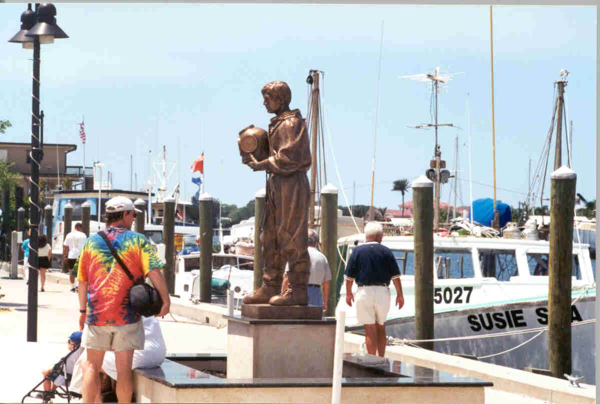A family stops along the Sponge Docks to view a statue commemorating Greek sponge divers who immigrated to Tarpon Springs in the early 1900s to harvest sponges in the Gulf of Mexico.