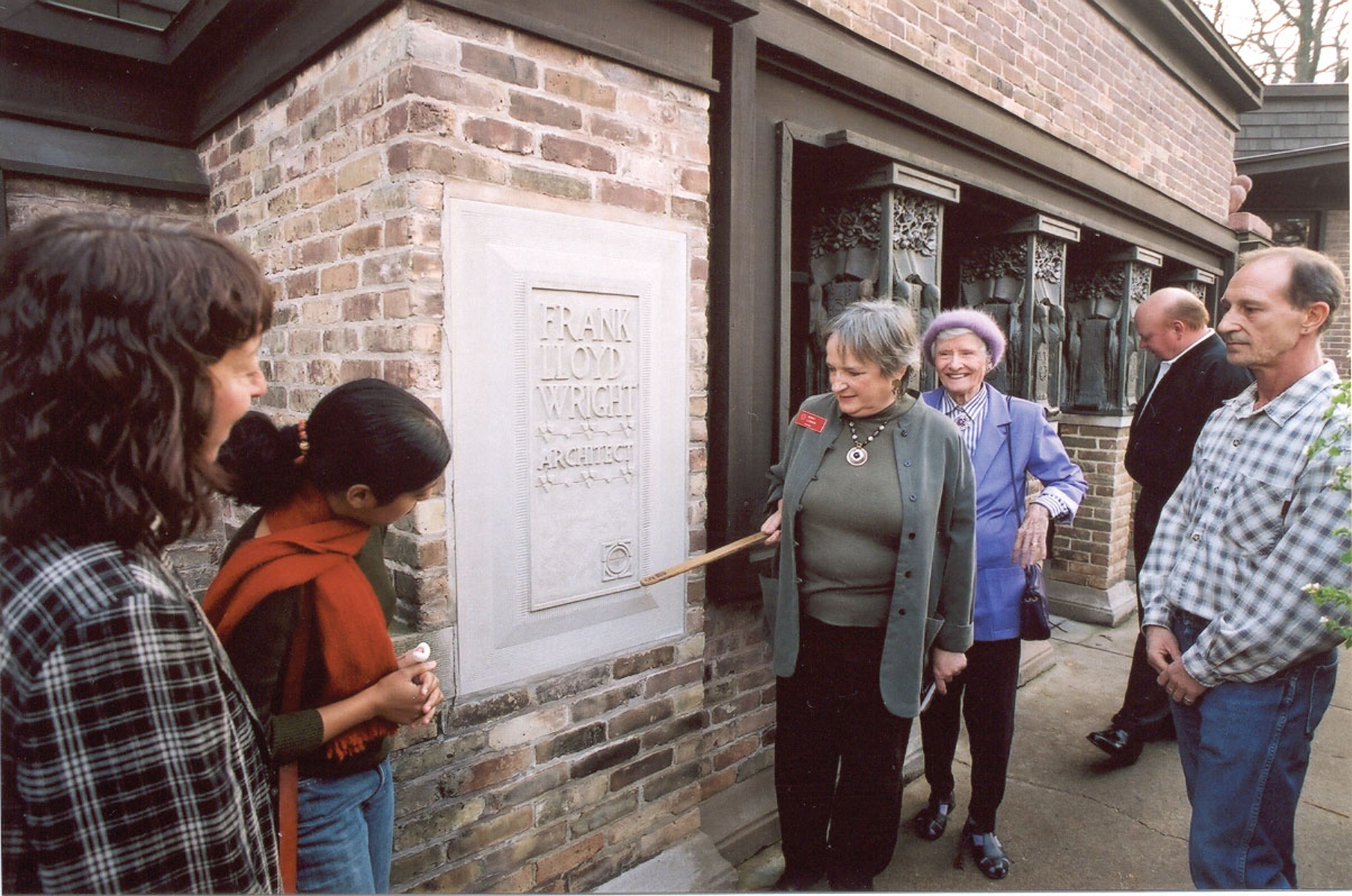 A guide talks with visitors at the entrance to the 1898 studio annex connected to the Frank Lloyd Wright home in Oak Park, Illinois
