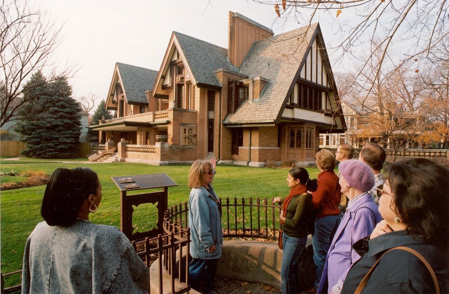 A guide talks with visitors outside the Nathan G. Moore House, also known as the Moore-Dugal Residence, designed by Frank Lloyd Wright. The house was built one block south of Wright's home and studio in the Chicago suburb of Oak Park, Illinois.