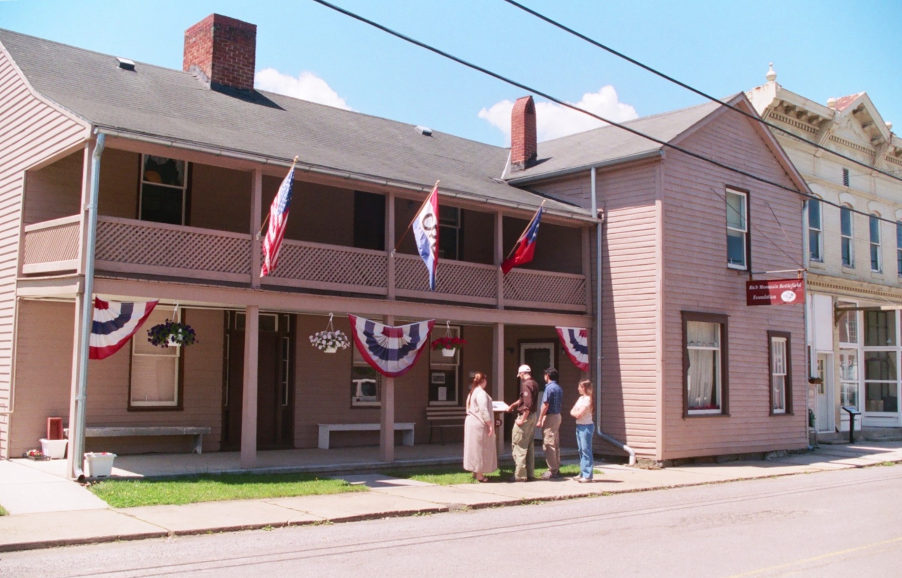 Visitors read an interpretive sign at the ca. 1850 Bushrod Crawford House, now part of the Beverly Heritage Center.