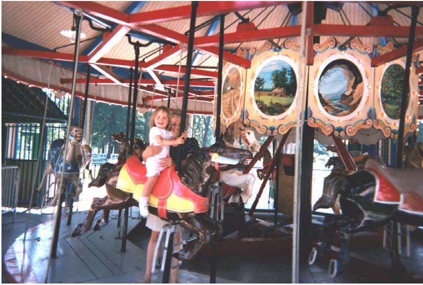 A little girl enjoys a ride on the 1920 Allen Herschell Company “Little Beauty” Carousel, located in Noblesville’s Forest Park.