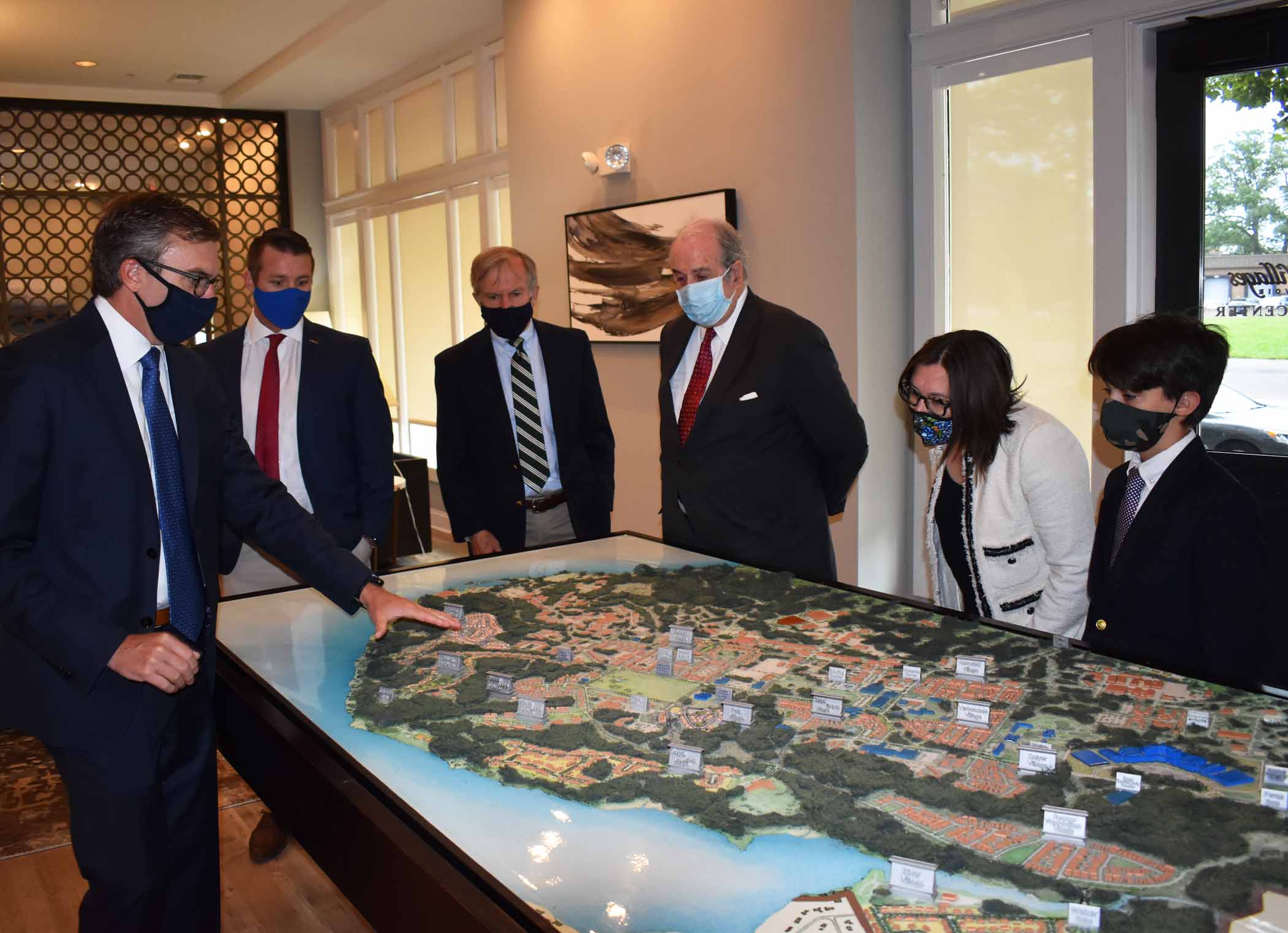 Alex Rhoads and Casey Nolan from Clark Realty show ACHP Executive Director John Fowler, Hon. Beehler, Chairman Jorjani, and Nickolas Jorjani a map of Fort Belvoir housing.