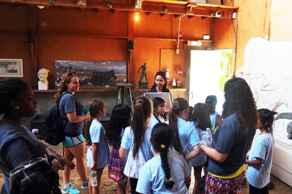 A Weir Farm volunteer guides a group of Girl Scouts through the Young Studio.