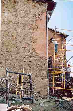 Community volunteers in Velarde, New Mexico, remove cement to reveal adobes at Our Lady of Guadalupe. (Photo credit: Antonio Martinez)