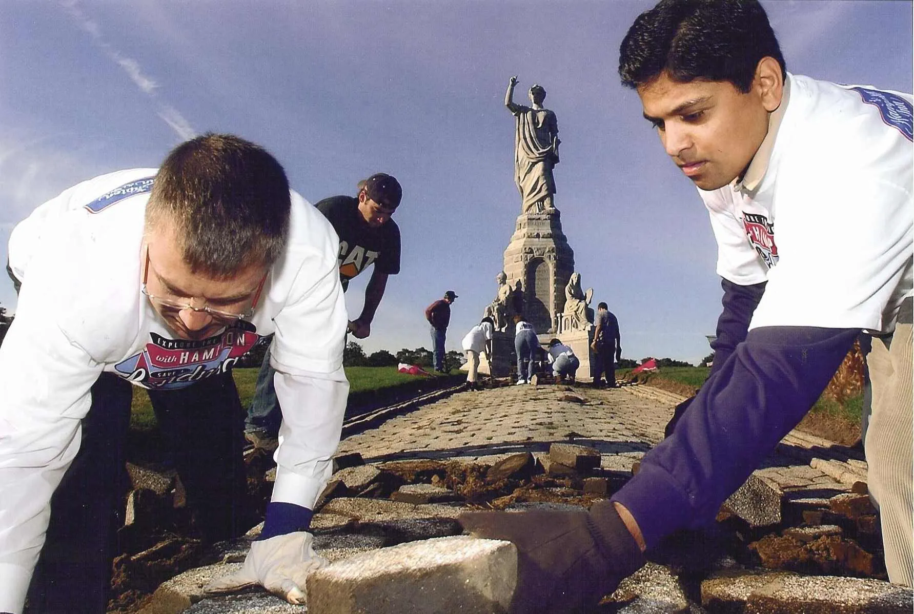 On Tuesday, October 14, 2003, the day following Columbus Day, Hampton volunteers from Boston and Providence traveled back to were the first Americans arrived to refurbish a symbolic piece of U.S. history. Since its dedication more that 100 years ago, the 81 foot tall National Monument to the Forefathers in Plymouth MA – one of the nations largest solid granite statues – has seen its image of the lady “Faith,” her pedestal and walkway of historic pavers deteriorate from time and weather. In an event to mark 