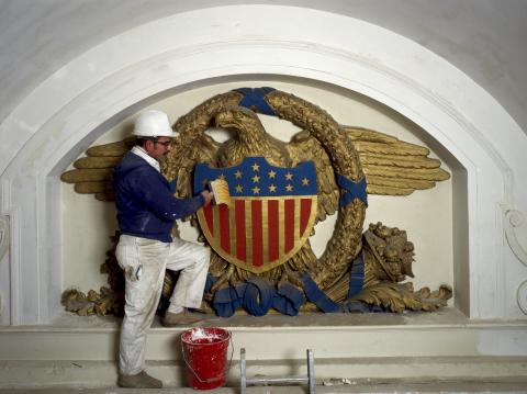 Worker rehabbing historic plaster eagle at Union Station, Washington, DC.