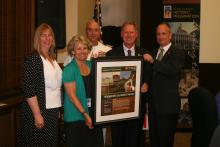 Business meeting presentation featuring poster on Los Flores Adobe on Marine Corps Base Camp Pendleton