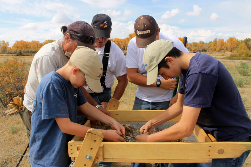 Volunteers screen dirt, searching for emigrant artifacts