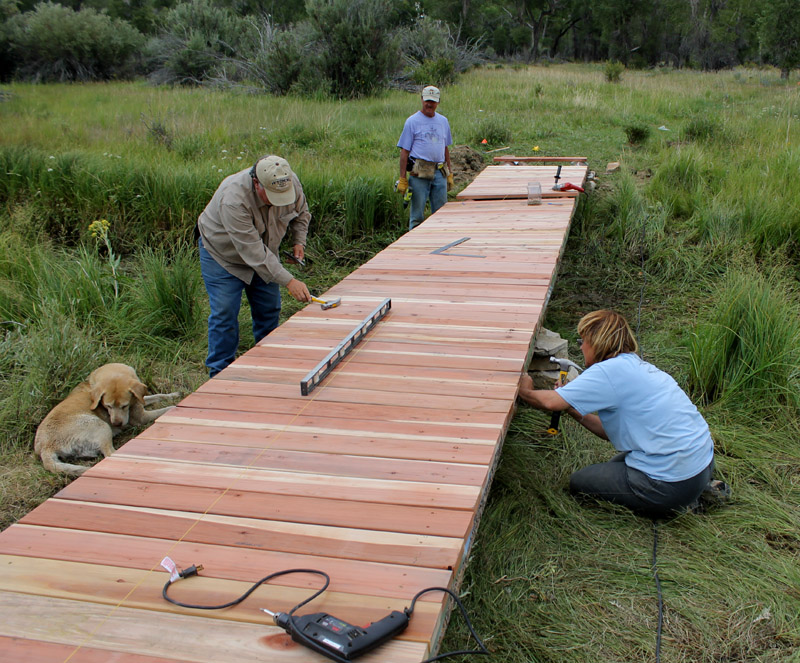 Volunteers build a footbridge